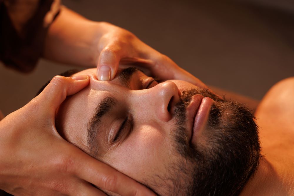 man experiencing crying during massage therapy