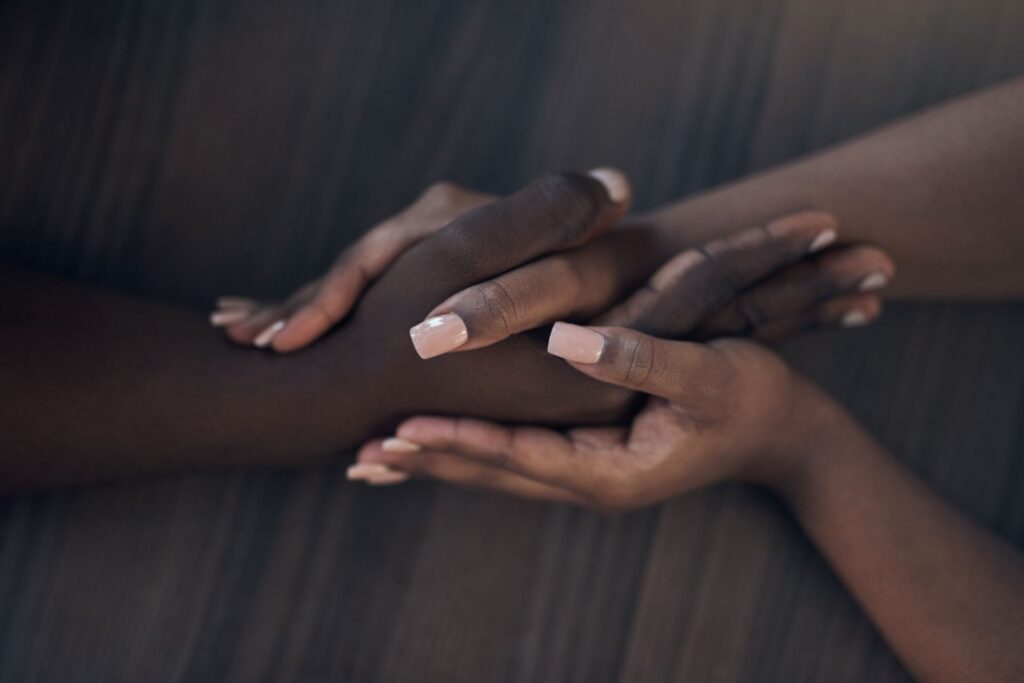 cropped-shot-of-an-unrecognizable-couple-holding- touch by trans massage services